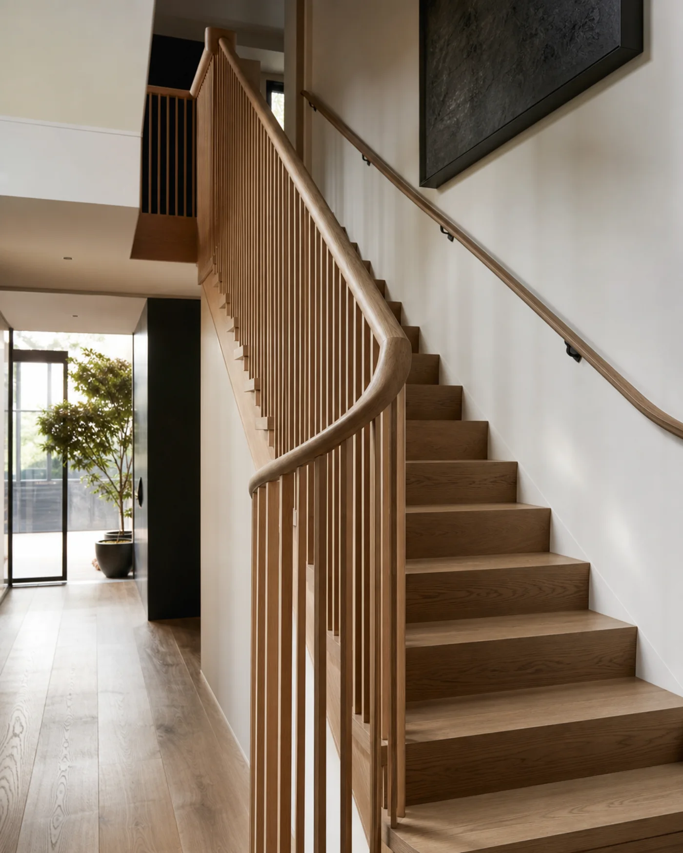 A crafted oak staircase with vertical timber balusters
